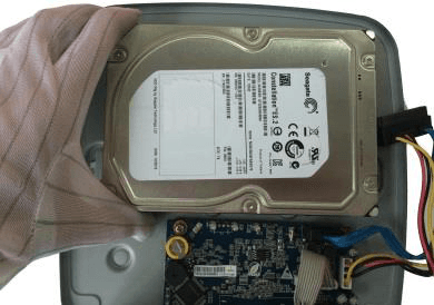 HDD lowered into the open Smart 1U chassis to align its screws with the holes