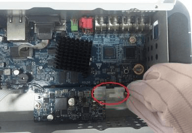 Battery cable pulled through the hole and connected into the cable port