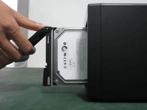 HDD being slid into the vertical chassis HDD box with the mounting bracket attached